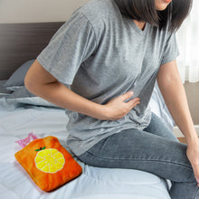 Small orange hot water bag for hand and feet warmth